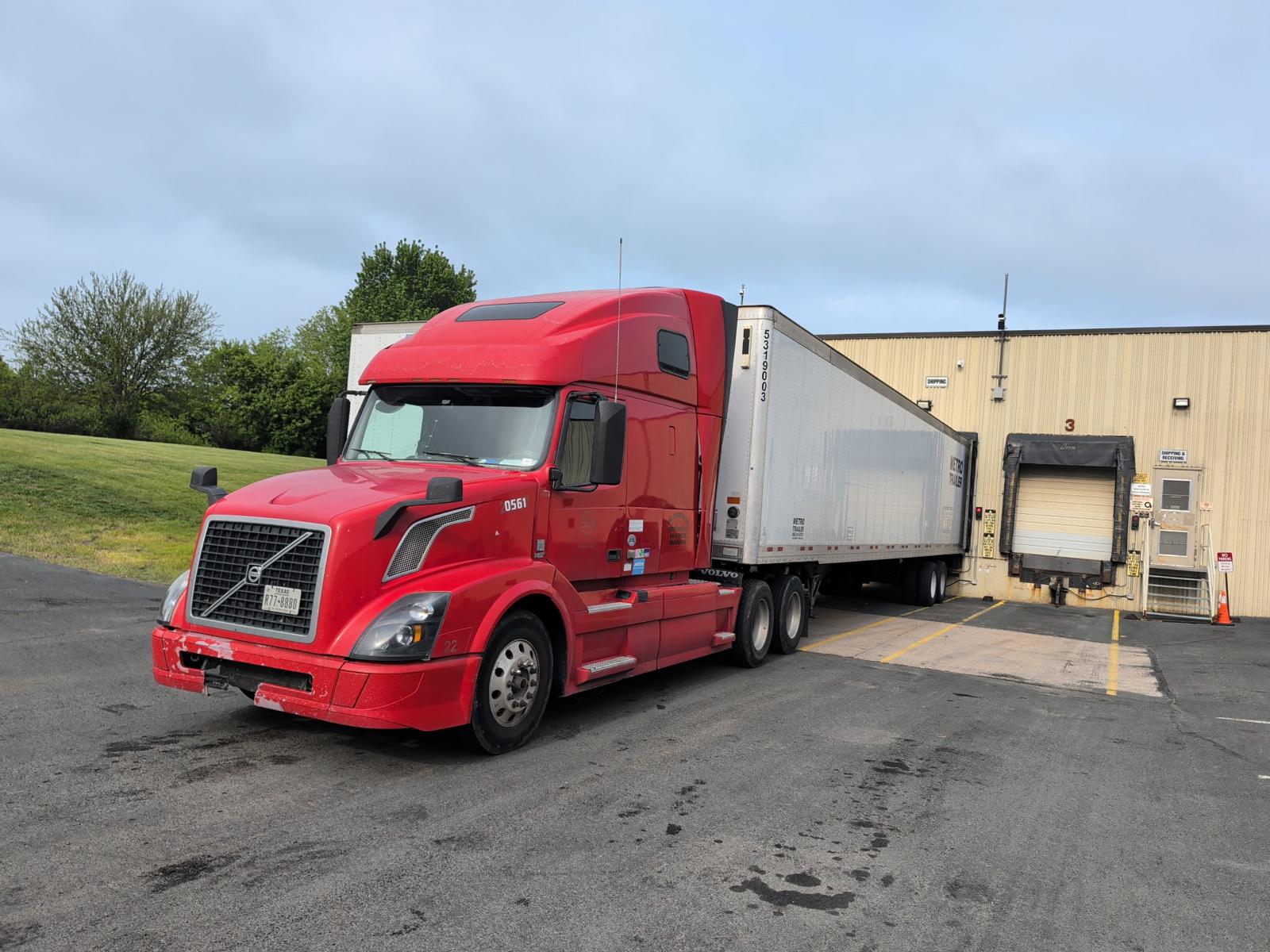 Red Volvo tractor with trailer